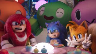 Knuckles, Sonic, and Tails pose for a photo at the Chao Garden Cafe in Sonic the Hedgehog 3.