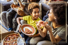 Mother and daughter sharing pizza