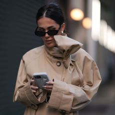 Woman using Rhode phone case with chrome nails 