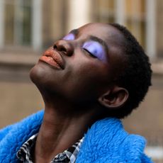 A model wears purple eyeshadow and red lipstick on February 29, 2020 in Paris, France. 