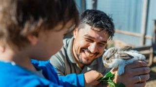 Dad holding rabbit with child