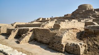 This is a photo of the Indus Valley Civilization&#039;s ancient stupa - one of the best preserved parts of Mohenjo Daro in Pakistan. It is a series of large steps made out of sand-colored bricks, interwoven with staircases. Right at the top is a circular dome.