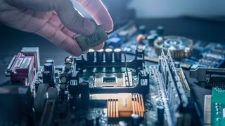 A technician putting a CPU into a socket of a computer motherboard