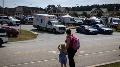 Girl and mother stand outside Georgia's Apalachee High School after school shooting