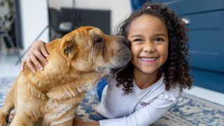 Young girl hugging her dog