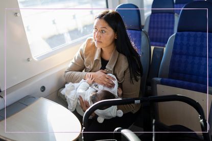 Nervous woman breastfeeding on a train