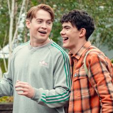 Kit Connor as Nick and Joe Locke as Charlie, talking outdoors, in 'Heartstopper' season 3.