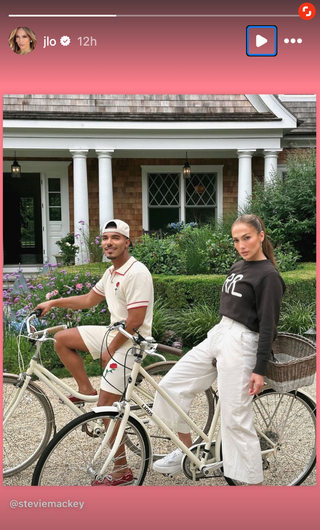 Jennifer Lopez posing on a bike in a knitted Ralph Lauren sweater.