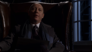 James Spader as Raymond Reddington sitting in a chair on The Blacklist