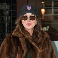 Dakota Johnson wearing a brown faux fur coat