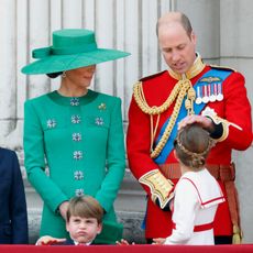 Princess Charlotte looks up at her father, Prince William