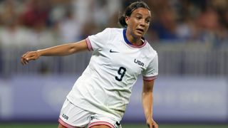 Mallory Swanson, in the white Team USA kit, celebrates a goal in the women's soccer at 2024 Olympic Games.