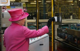 Britain's Queen Elizabeth II presses a button to start a new packaging machine during a visit to the Heinz food factory in Wigan, northern England, on May 21, 2009. Britain's Queen Elizabeth II on Thursday visited the factory, which is celebrating its Golden Jubilee in the UK