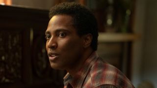 Boy Willie Charles (John David Washington) sits at the piano in The Piano Lesson