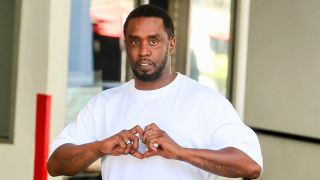 P. Diddy shares a heart with his hands in a white tee shirt before his 2024 arrest. 