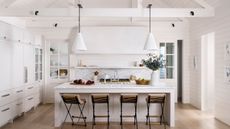 kitchen with white walls and cabinets and wooden floor