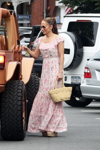 Jennifer Lopez in the Hamptons entering a jeep while wearing a floral pink dress