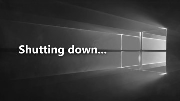 A black-and-white stock Windows 10 walppaper with a shutting down script on it