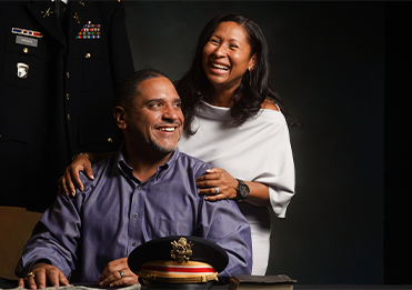 man and woman smiling in a room