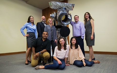 Group of employees pose and smile