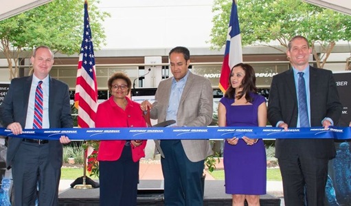 Group of individuals cut ribbon outside