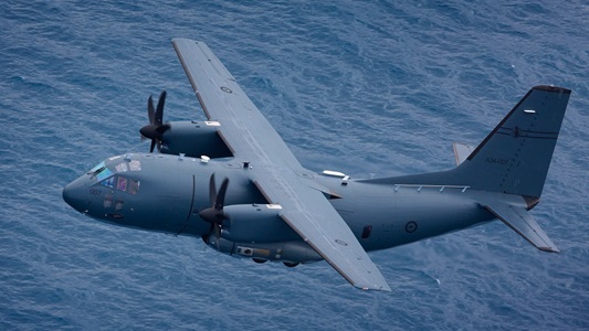 military aircraft flying above water