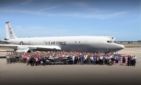 People standing in front of an airplane