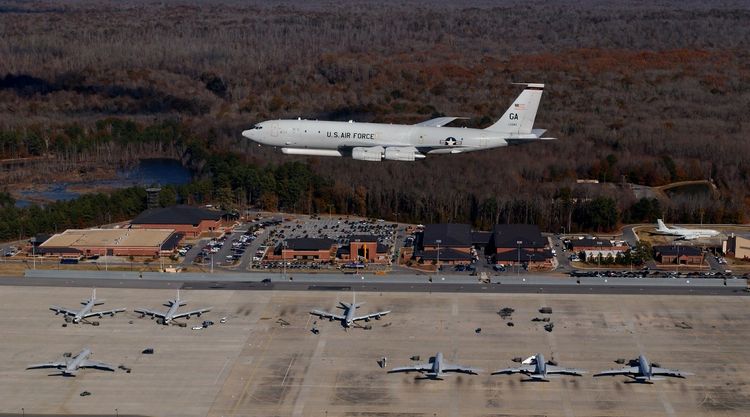 Airplane flying over a fleet of airplane