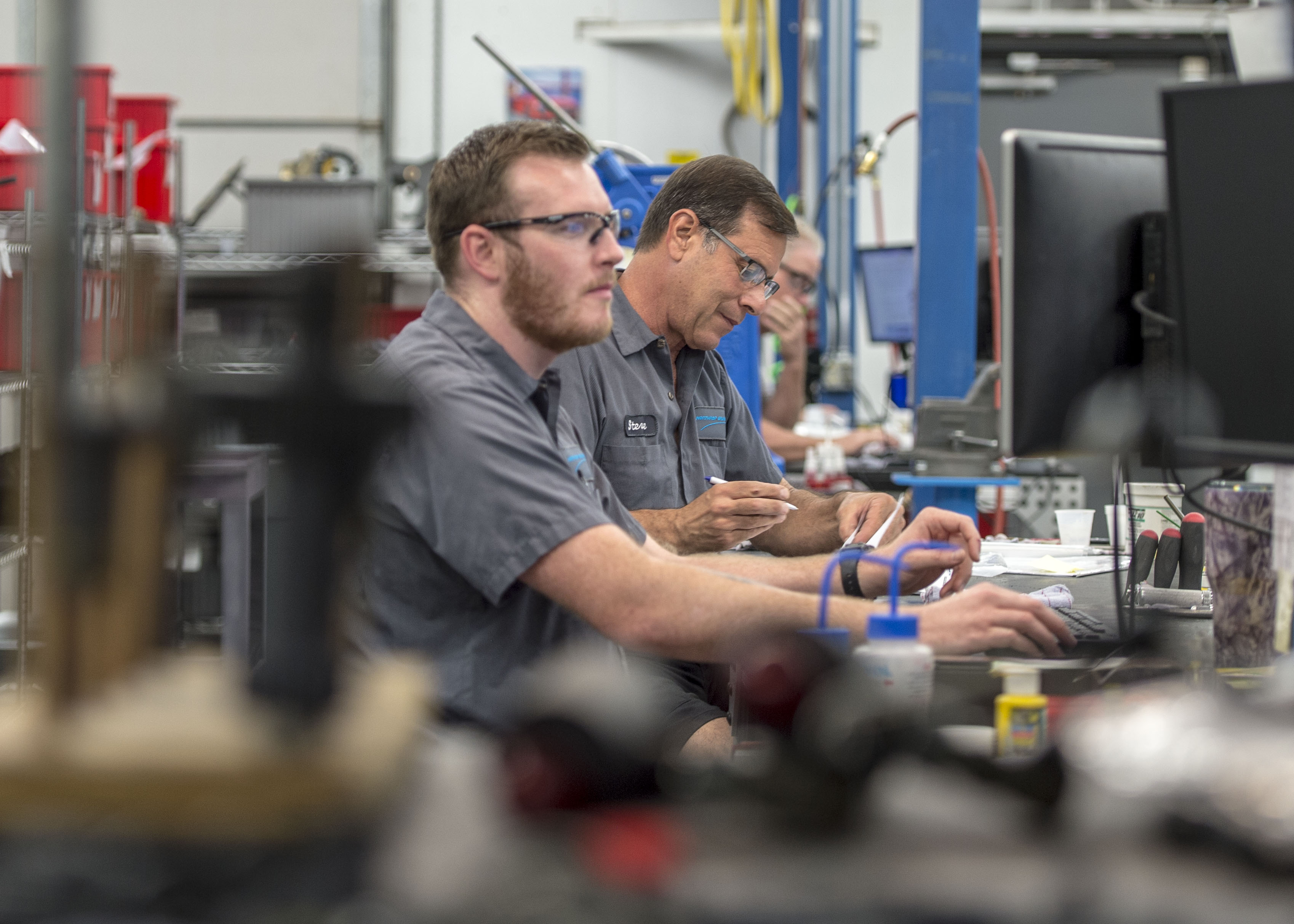 two males working on computers