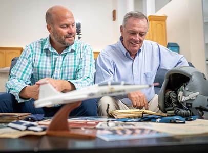 father and son looking at old photos