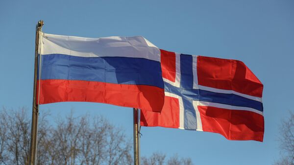 Bandeiras da Rússia e da Noruega durante cerimônia de deposição de uma coroa de flores no monumento do Soldado Russo por parte da delegação norueguesa, representada por veteranos do serviço militar, povoado Mezhdurechie, região de Murmansk, Rússia, 21 de outubro de 2019 - Sputnik Brasil