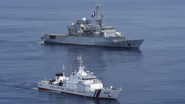 A fragata de vigilância da Marinha Francesa Prairial (F731), no topo, e o navio patrulha da Guarda Costeira Filipina BRP Capones (MRRV-4404) conduzem um exercício de passagem (PASSEX) nas águas do mar do Sul da China - Sputnik Brasil