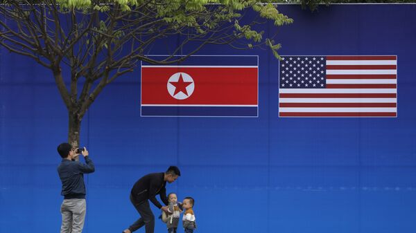 Pessoas tiram fotos em frente à bandeira da Coreia do Norte e dos EUA, em Hanói, Vietnã, 24 de fevereiro de 2019 - Sputnik Brasil