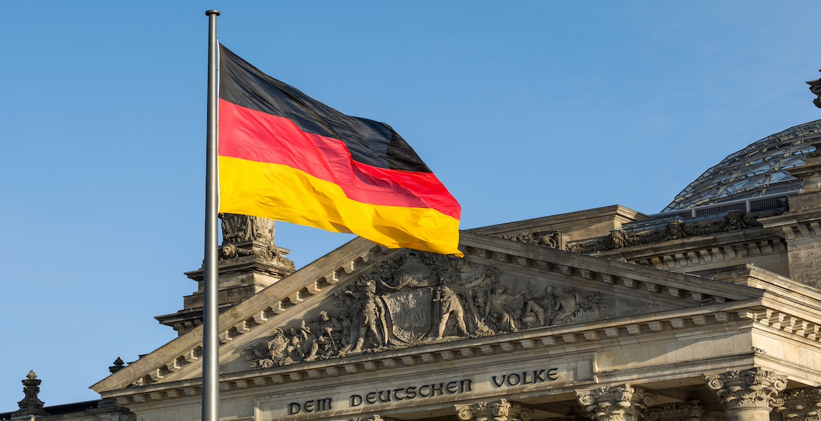 Image of the German flag in front of the Reichstag building