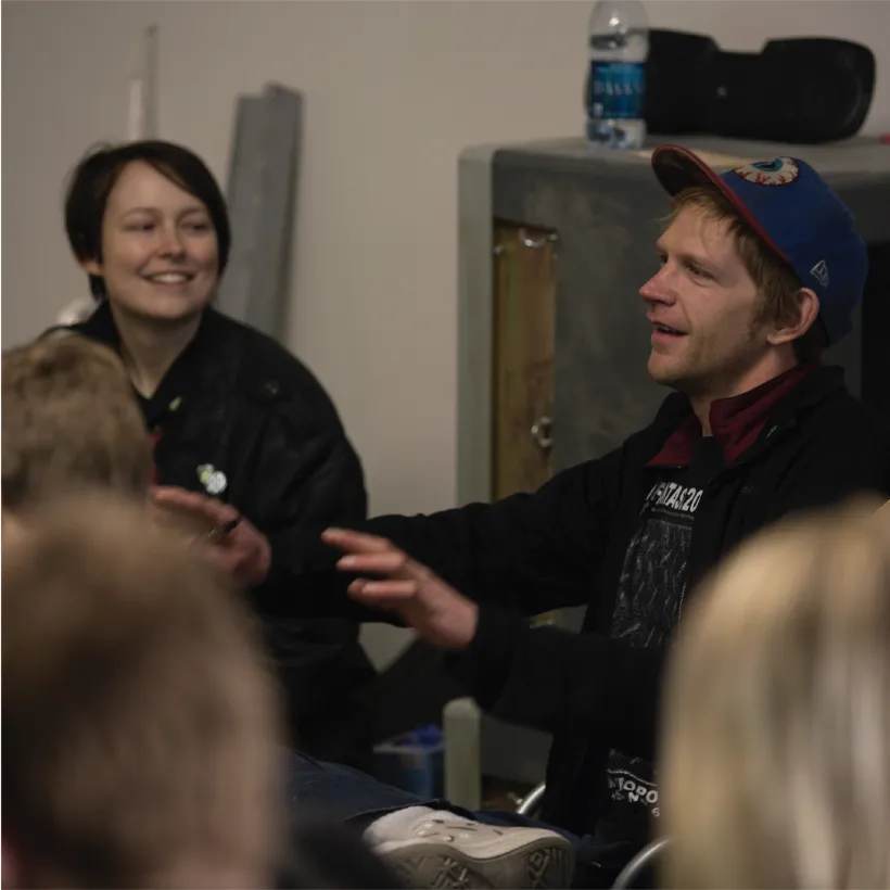 Meow Wolf co-founder Benji holding hands out and speaking to group