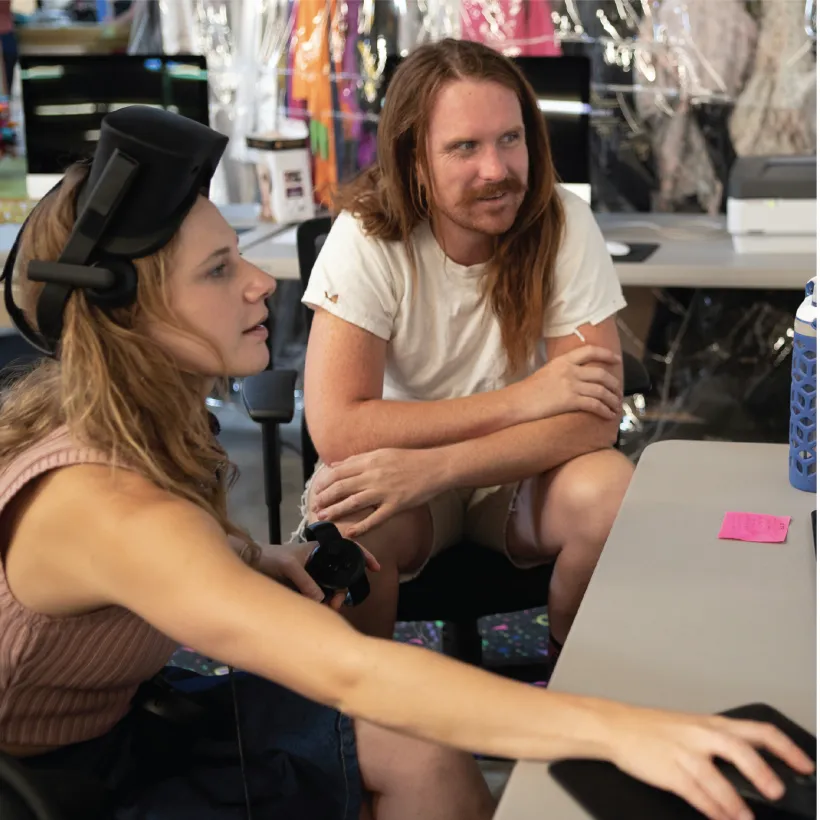 two people looking at something on a computer