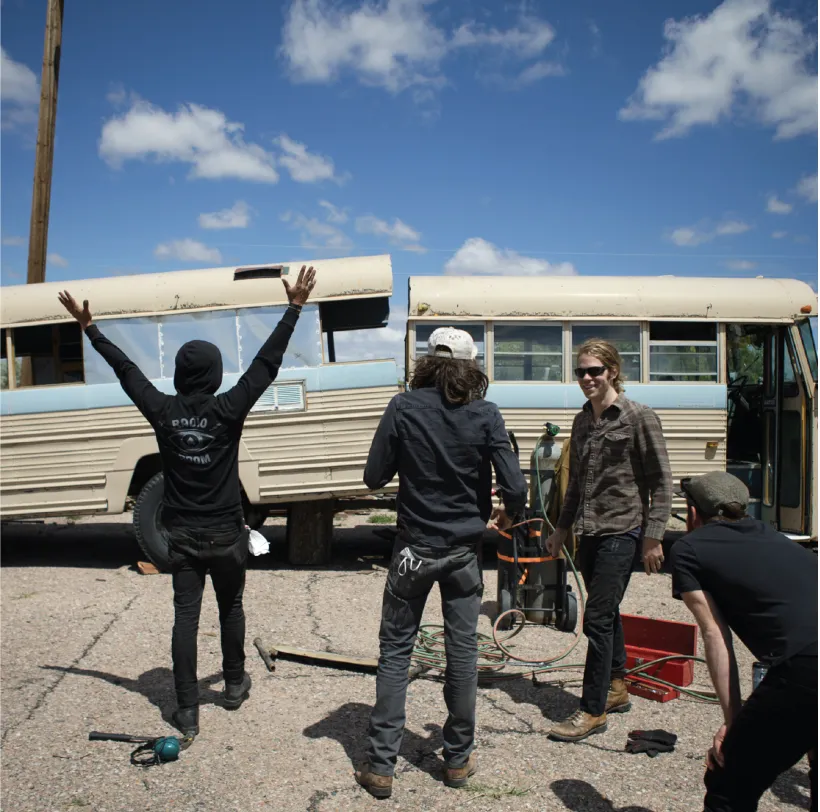 people standing outside near a bus