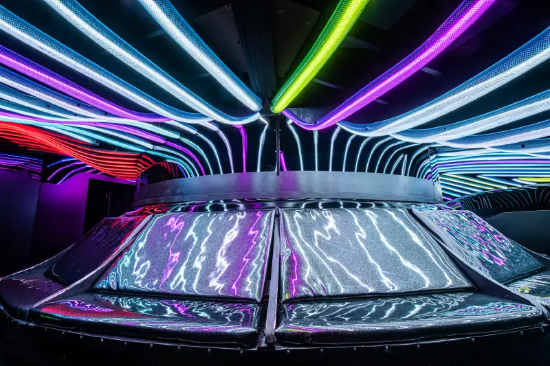 A space-ship like object with glowing lights emanating from the top at Meow Wolf Santa Fe