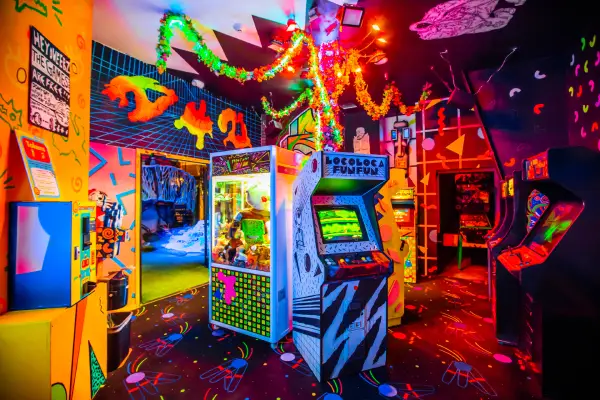 A colorfully painted arcade with glowing lights.