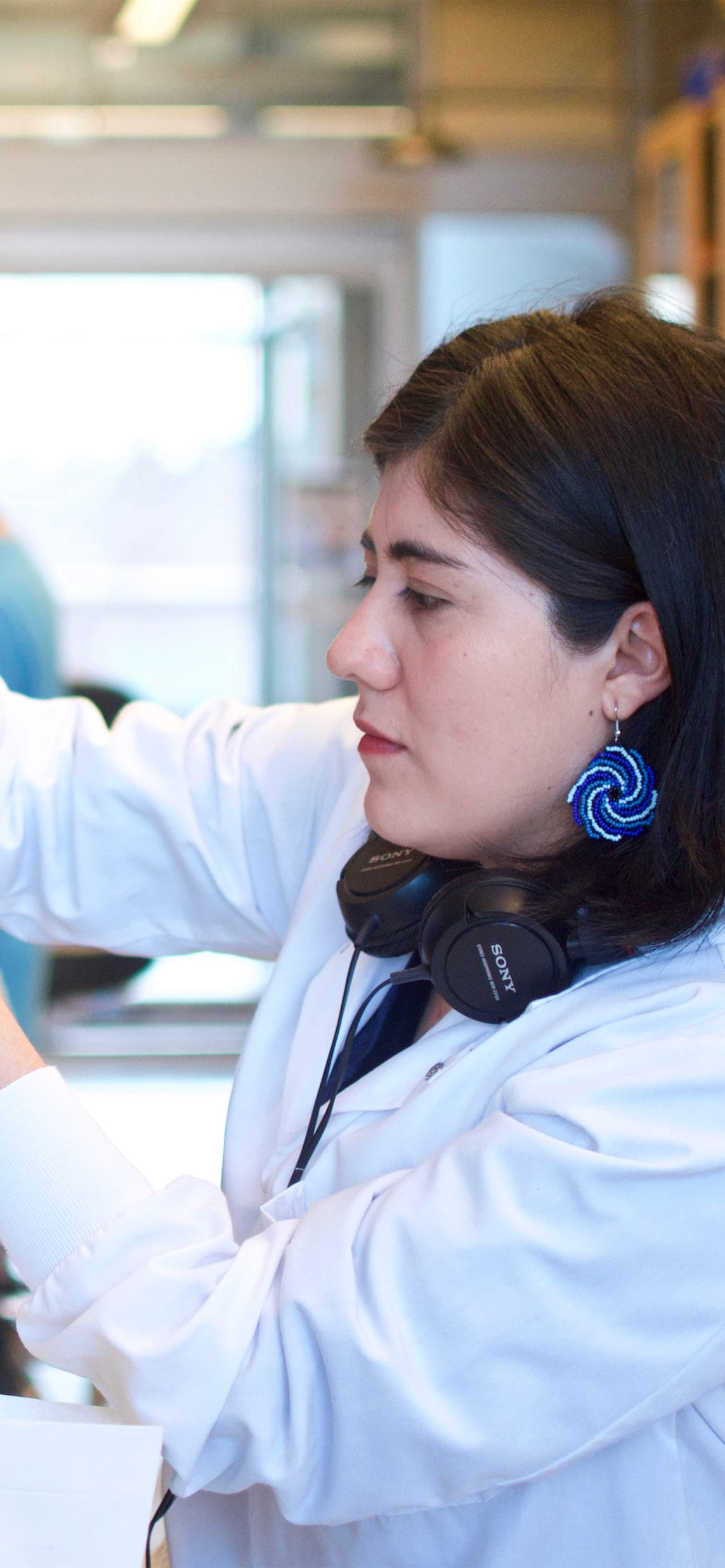 Woman pouring chemicals in lab