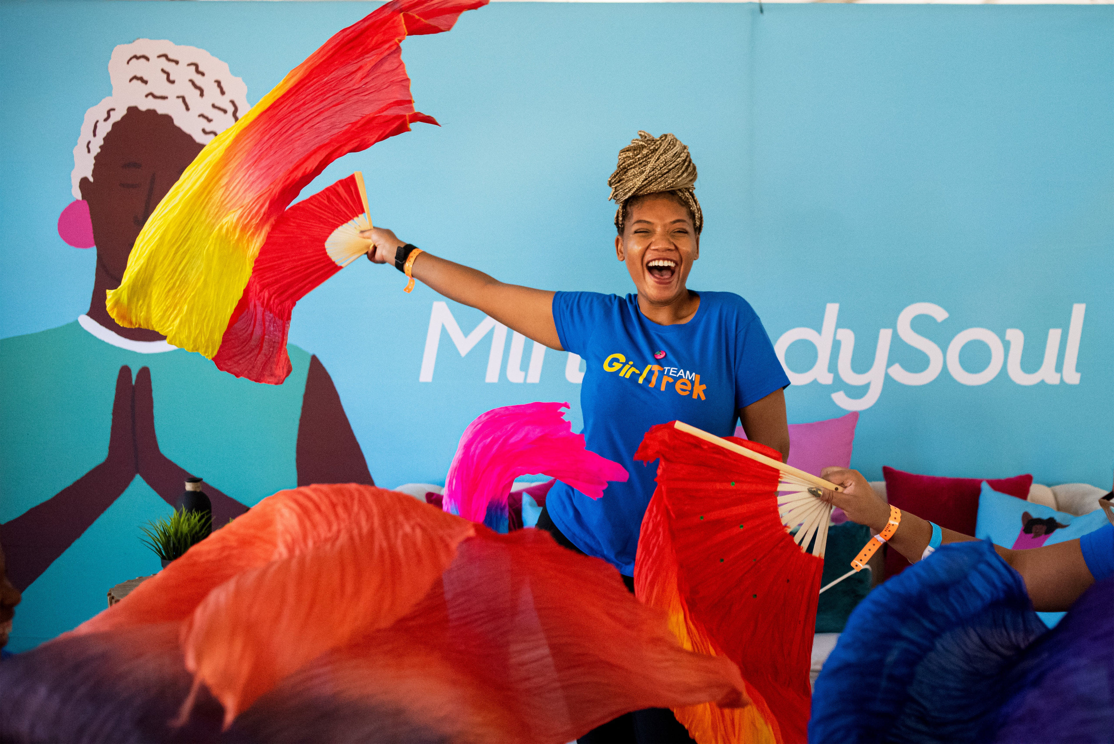 Woman smiling and waving scarf