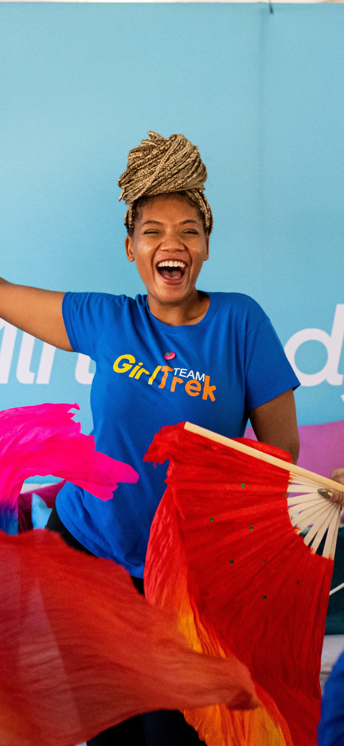 Woman smiling and waving scarf