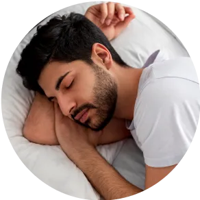 A man peacefully sleeping in bed with his head resting on the pillow