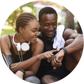 Fitness enthusiasts, a man and a woman, monitoring their activity with wearable trackers