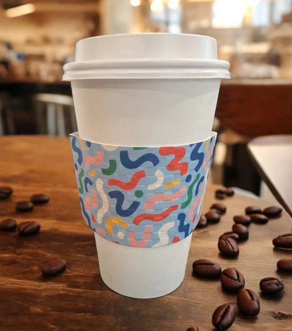 A cup of coffee sitting on top of a wooden table.