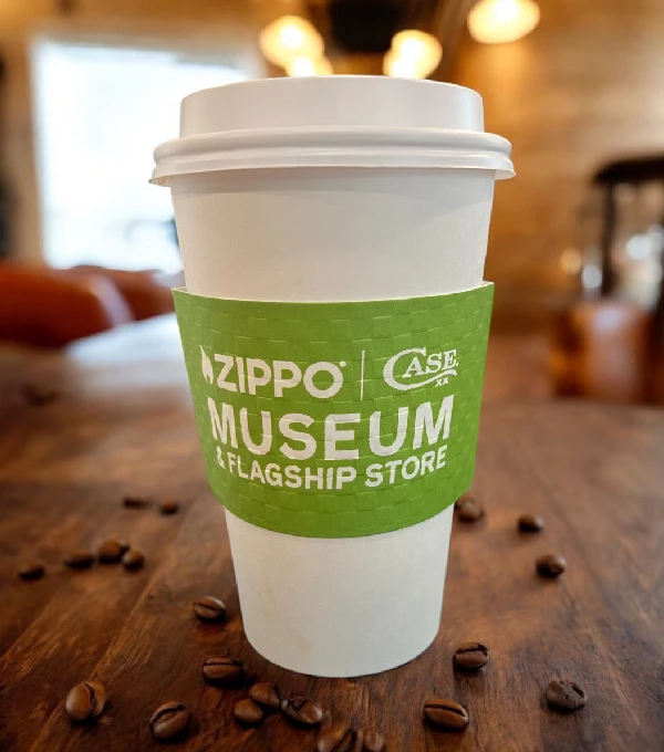 A cup of coffee sitting on top of a wooden table.