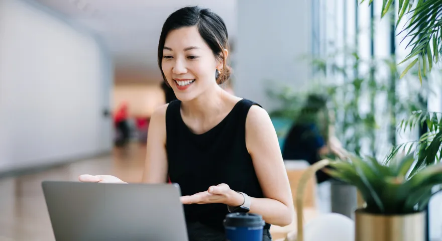 Woman smiling and looking at a computer screen