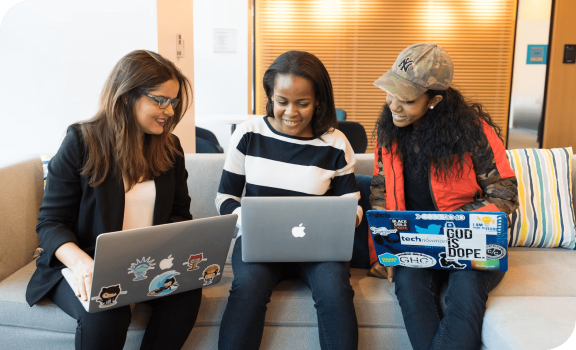 Employees looking into a laptop.