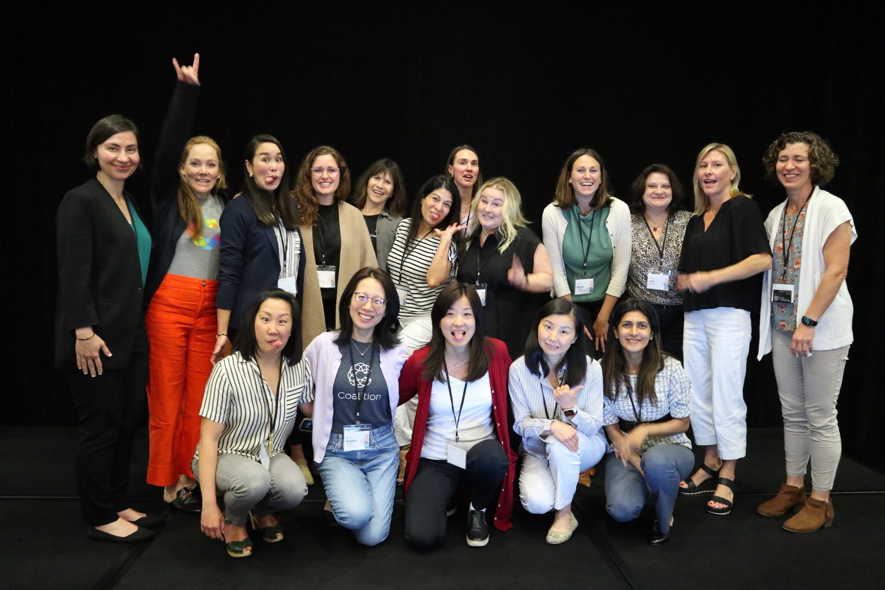 A group of Coalition employees posing for a photo at a professional event.