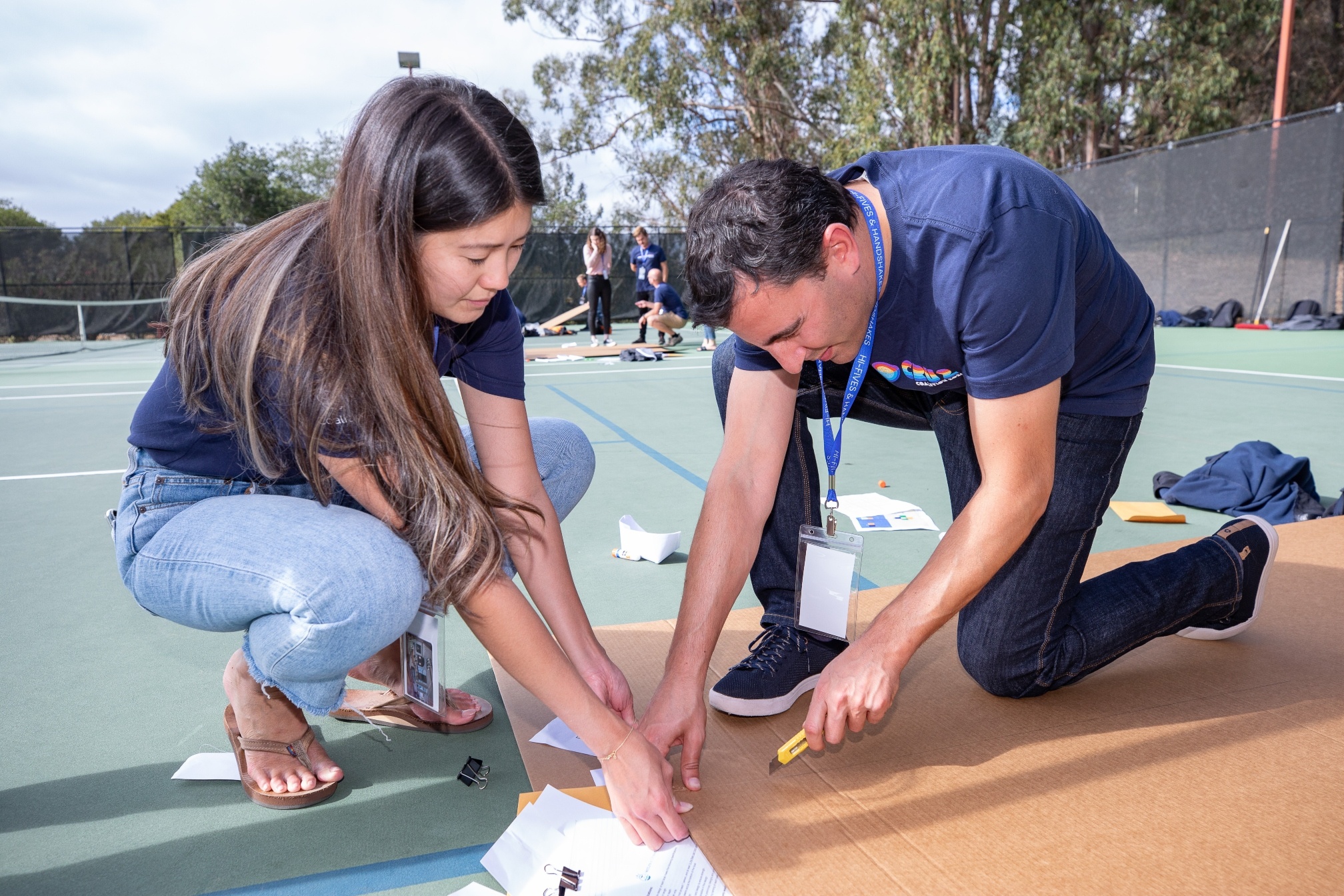 Two Coalition employees collaborating at a team bonding event on a creative competition.